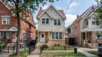 Detached two-family brick homes on a tree-lined R3A-zoned street in Queens, NYC.
